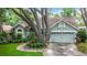 Beautiful home exterior showcasing a well-maintained lawn and mature trees for added privacy at 2973 Spring Oak Ct, Palm Harbor, FL 34684