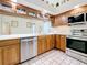 Updated kitchen featuring wood cabinets, quartz counters, stainless steel appliances and decorative glass front cabinets at 2973 Spring Oak Ct, Palm Harbor, FL 34684