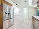 Spacious kitchen with stainless steel refrigerator, tile floors, and ample cabinet space at 2973 Spring Oak Ct, Palm Harbor, FL 34684