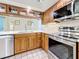 Updated kitchen with stainless steel appliances, quartz countertops, tile backsplash, and wood cabinets at 2973 Spring Oak Ct, Palm Harbor, FL 34684