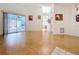 Expansive living room featuring wood floors, sliding glass doors, and neutral walls for a bright and open space at 2973 Spring Oak Ct, Palm Harbor, FL 34684