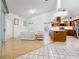 Open-concept living room flows into a bright kitchen with wood cabinets and stainless steel appliances at 2973 Spring Oak Ct, Palm Harbor, FL 34684