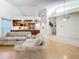 Bright and airy living room adjacent to an updated kitchen with wood cabinets and stainless steel appliances at 2973 Spring Oak Ct, Palm Harbor, FL 34684