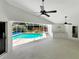 Large covered pool area with ceiling fans, a wet bar, and ample space for outdoor entertaining at 2973 Spring Oak Ct, Palm Harbor, FL 34684
