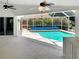 Spacious screened-in pool area with ceiling fans and a covered patio, perfect for relaxing and entertaining at 2973 Spring Oak Ct, Palm Harbor, FL 34684