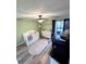 Bedroom featuring a crib, dresser, ceiling fan, and a sliding glass door to the lanai at 30 Tads Trl, Oldsmar, FL 34677