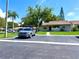 Exterior view of house features a neat front lawn and paved parking area at 30 Tads Trl, Oldsmar, FL 34677