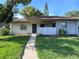 Front view of a well-maintained house with an inviting entrance and lush green lawn at 30 Tads Trl, Oldsmar, FL 34677