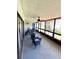 Covered lanai with outdoor seating, ceiling fan, and views of the lush landscaping at 30 Tads Trl, Oldsmar, FL 34677