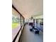 Screened lanai with comfortable seating and views of the landscaped backyard at 30 Tads Trl, Oldsmar, FL 34677