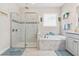 Elegant bathroom featuring a soaking tub, walk-in shower, and natural lighting at 30801 Parrot Reef Ct, Wesley Chapel, FL 33545