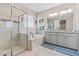 Relaxing bathroom with a soaking tub, glass-enclosed shower, and double vanities at 30801 Parrot Reef Ct, Wesley Chapel, FL 33545
