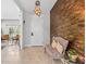 An elegant home entrance with modern light fixture, accent wall, and seating at 30801 Parrot Reef Ct, Wesley Chapel, FL 33545