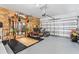 Spacious garage featuring a home gym, storage, and room for vehicles at 30801 Parrot Reef Ct, Wesley Chapel, FL 33545