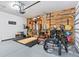 Organized garage space with fitness equipment, storage solutions, and vehicle parking at 30801 Parrot Reef Ct, Wesley Chapel, FL 33545