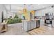 Open-concept kitchen featuring stainless appliances, island with seating, and seamless flow to the living area at 30801 Parrot Reef Ct, Wesley Chapel, FL 33545