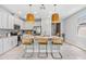 Bright kitchen with a center island featuring granite countertops, seating, stainless appliances, and pendant lighting at 30801 Parrot Reef Ct, Wesley Chapel, FL 33545