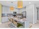 Bright kitchen with a center island featuring granite countertops, seating, stainless appliances, and pendant lighting at 30801 Parrot Reef Ct, Wesley Chapel, FL 33545