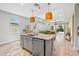 Bright kitchen with a center island featuring granite countertops, stainless appliances, and open to the living area at 30801 Parrot Reef Ct, Wesley Chapel, FL 33545