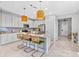 Bright kitchen with a center island featuring granite countertops, seating, stainless appliances, and pendant lighting at 30801 Parrot Reef Ct, Wesley Chapel, FL 33545