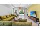 Spacious living room featuring plush seating, pendant lighting, and a view of the pool at 30801 Parrot Reef Ct, Wesley Chapel, FL 33545
