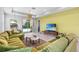 Spacious living room with plush seating, pendant lighting, and seamless flow to the outdoor pool area at 30801 Parrot Reef Ct, Wesley Chapel, FL 33545