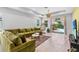 Spacious living room featuring plush seating, pendant lighting, and sliding glass doors to the outdoor area at 30801 Parrot Reef Ct, Wesley Chapel, FL 33545