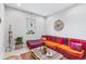 Cozy living room with a vibrant, multi-colored cushioned sofa and a rustic coffee table near the window at 30801 Parrot Reef Ct, Wesley Chapel, FL 33545