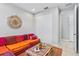 Comfortable seating area with bright cushions, decorative wall art, and closet in this home at 30801 Parrot Reef Ct, Wesley Chapel, FL 33545