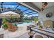 Relaxing patio with views of the pool, perfect for entertaining and enjoying outdoor living at 30801 Parrot Reef Ct, Wesley Chapel, FL 33545