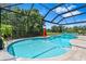 Gorgeous screened-in pool featuring a serene backyard view and a relaxing spa at 30801 Parrot Reef Ct, Wesley Chapel, FL 33545