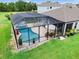 A screened-in pool and spa area with ample space for outdoor furniture at 30801 Parrot Reef Ct, Wesley Chapel, FL 33545
