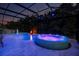 Sparkling screened pool and hot tub feature relaxing fountain and ambient lighting at 30801 Parrot Reef Ct, Wesley Chapel, FL 33545