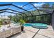 Relaxing screened-in pool and spa area with stylish patio furniture for outdoor lounging at 30801 Parrot Reef Ct, Wesley Chapel, FL 33545