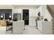 Open kitchen with white cabinets, stainless steel appliances, and a breakfast bar at 36033 Joseph Blake St, Zephyrhills, FL 33541