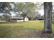 Spacious backyard featuring lush greenery and a screened-in patio ideal for outdoor relaxation at 3705 Bruton, Plant City, FL 33565