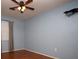 A bedroom featuring light blue walls, hardwood floors, and a ceiling fan at 3705 Bruton, Plant City, FL 33565