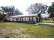 Charming brick home with a long driveway and a lush green yard at 3705 Bruton, Plant City, FL 33565