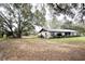 Quaint brick house with mature trees and lush greenery at 3705 Bruton, Plant City, FL 33565