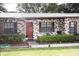 Charming townhome with brick facade, tidy landscaping, and a charming red front door at 3705 Bruton, Plant City, FL 33565