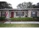 Inviting townhome with brick facade, tidy landscaping, and a charming red front door at 3705 Bruton, Plant City, FL 33565
