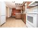 Kitchen featuring wood cabinets, white appliances, and tiled floors at 3705 Bruton, Plant City, FL 33565