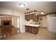Kitchen featuring wood cabinets, white appliances, tiled floor, and an eat-in counter at 3705 Bruton, Plant City, FL 33565