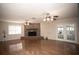 A living room featuring a brick fireplace, ceiling fans, and french doors at 3705 Bruton, Plant City, FL 33565
