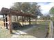 Rustic open shelter structure, great for storage or livestock, in a grassy, fenced field at 3705 Bruton, Plant City, FL 33565