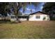 Charming home exterior featuring a screened-in porch, well-maintained lawn, and mature trees at 3705 Bruton, Plant City, FL 33565