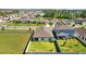 Aerial view displaying a Gathering-friendly neighborhood with tree-lined streets and a tranquil lake at 3935 Capri Coast Dr, Plant City, FL 33565