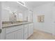 Bright bathroom with double sinks, granite vanity, shower with glass doors, and linen closet for storage at 3935 Capri Coast Dr, Plant City, FL 33565
