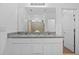 Bright bathroom with double sinks, granite vanity, shower with glass doors, and linen closet for storage at 3935 Capri Coast Dr, Plant City, FL 33565