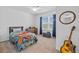 Cozy bedroom with ample natural light, ceiling fan, guitar and decor at 3935 Capri Coast Dr, Plant City, FL 33565